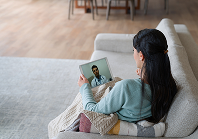A sick woman doing a virtual appointment with her primary care provider
